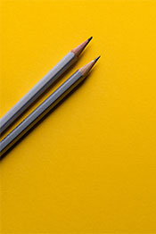 Two pencils on yellow background